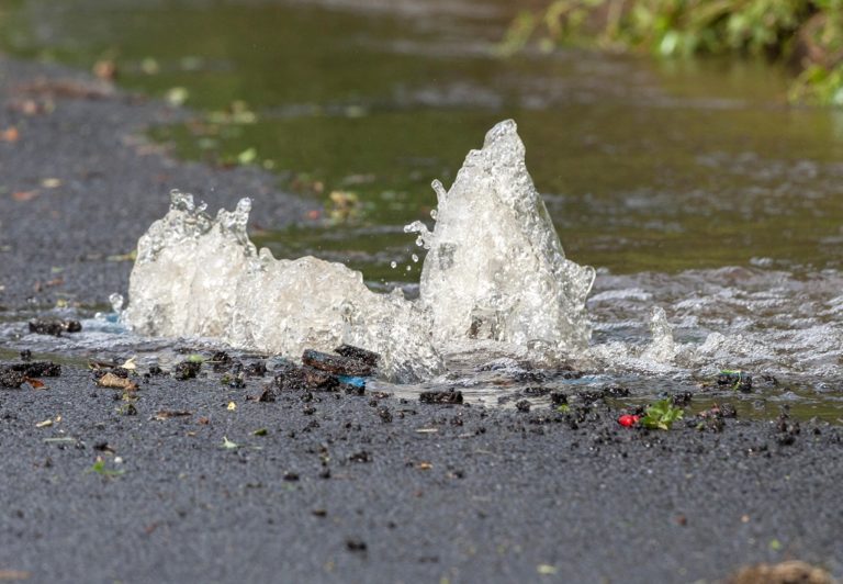 Picture showing water leaking from a burst water main