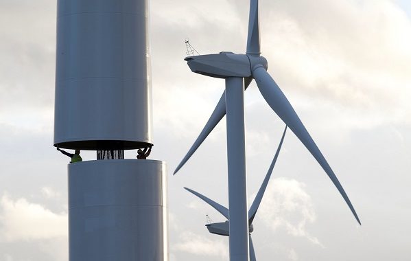 An image showing two men helping to build a wind turbine in County Durham