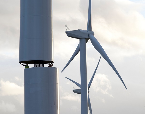 An image showing two men helping to build a wind turbine in County Durham