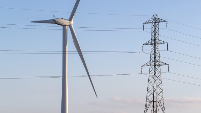 A wind turbine and electricity pylon