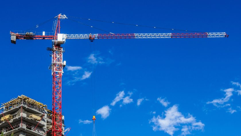 A tower crane against a blue sky