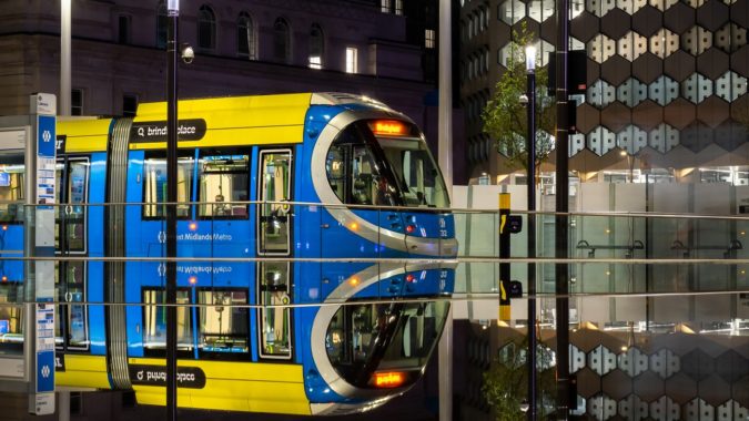 A Birmingham tram reflected in a wet platform