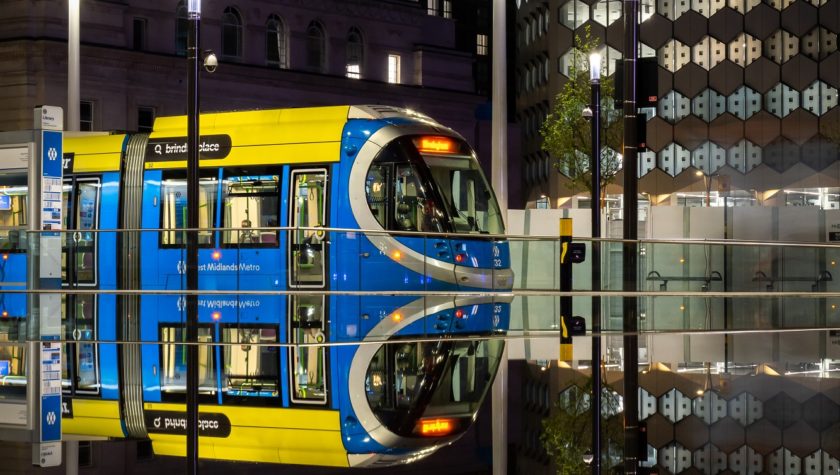 A Birmingham tram reflected in a wet platform