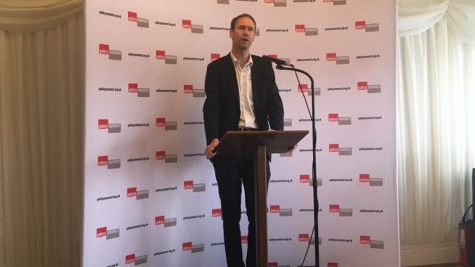 Phil Graham at a lectern giving a speech