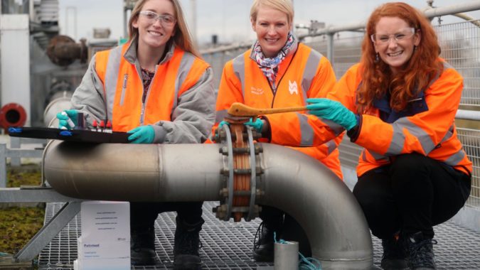 Three female engineers in hi-vis jackets