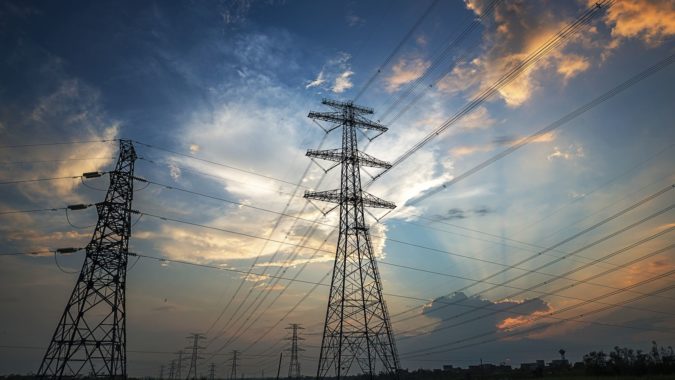 Electricity pylon against a cloudy sky