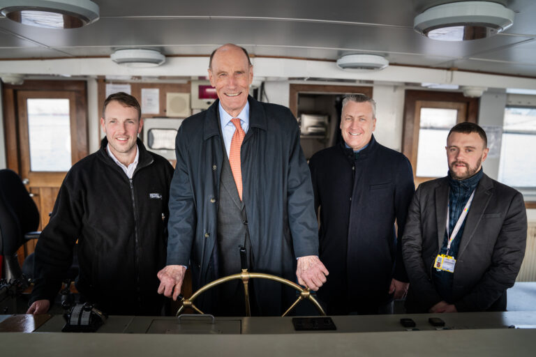 Sir John Armitt at the helm of the Mersey ferry