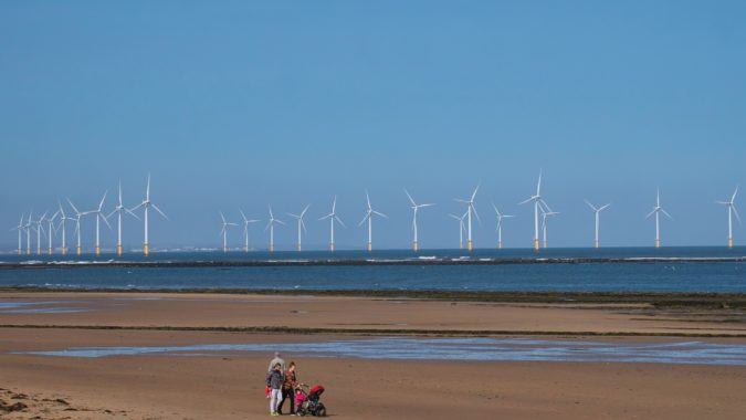 Wind turbines of the offshore Redcar / Teeside Wind Farm, located on the north east coast of England in the UK - taken on a sunny day with a blue sky at the end of summer.