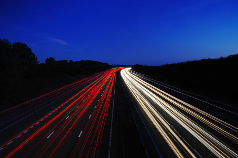 A motorway at night showing car headlights