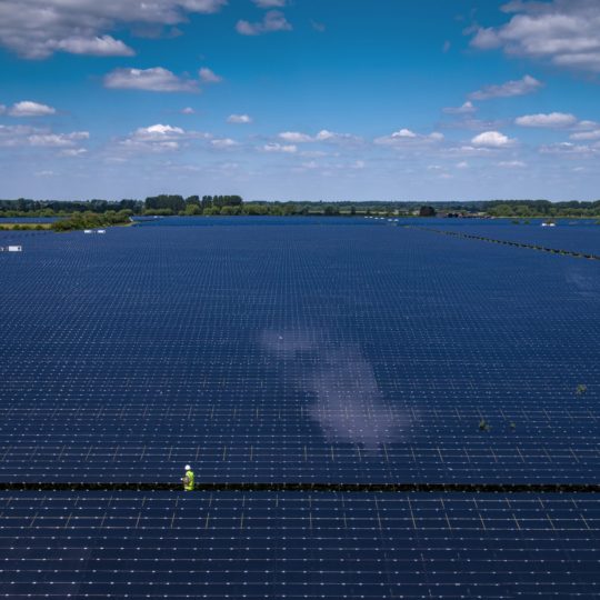 Man among huge solar power plant