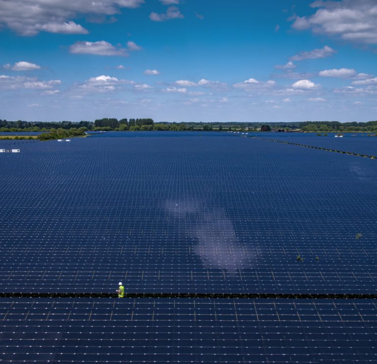 Man among huge solar power plant