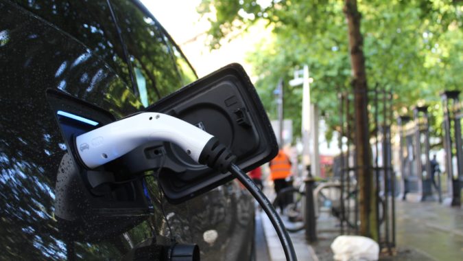 A close up of a car using a public EV chargepoint