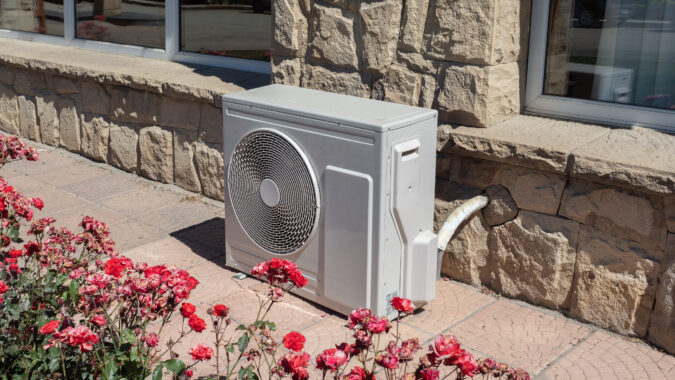 picture of a heat pump by a wall