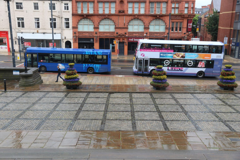 Two buses waiting to pick up passengers in Leeds
