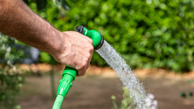 A garden being watered with a hosepipe