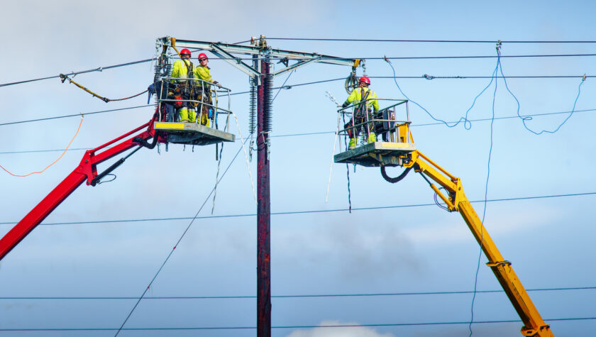 Two linemen working on an electricity line