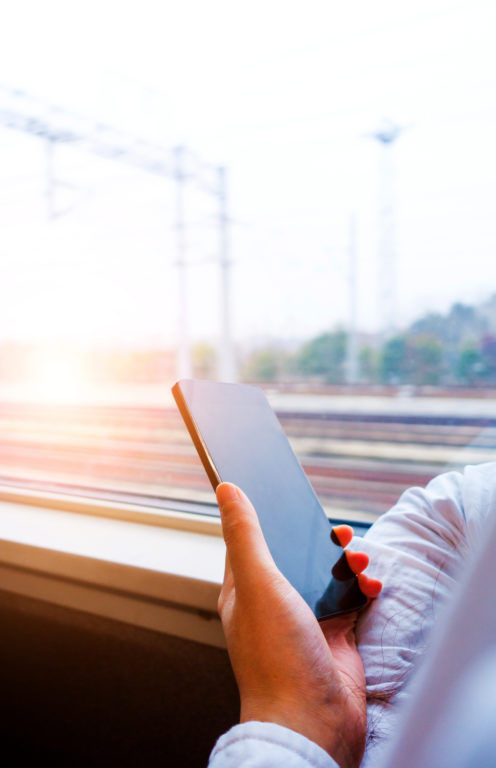 A person on a train holding a mobile phone