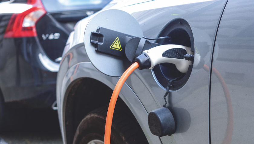 Close up of a charger plugged into an electric vehicle