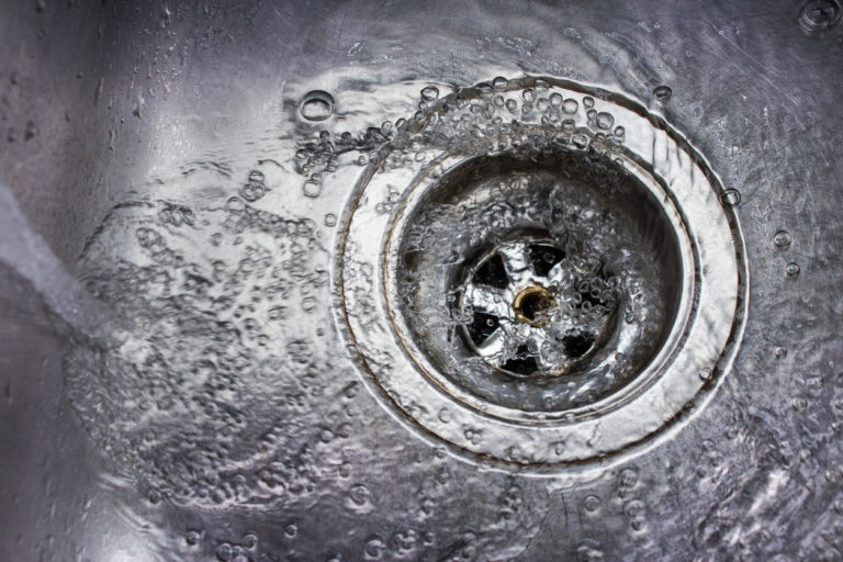 Water running down a metal drain.