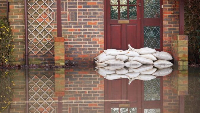 flooded house with sandbags at front door