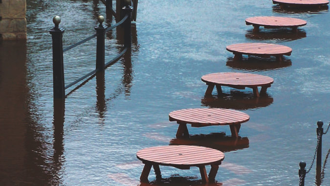 Tables next to an overlowing flooded river in York